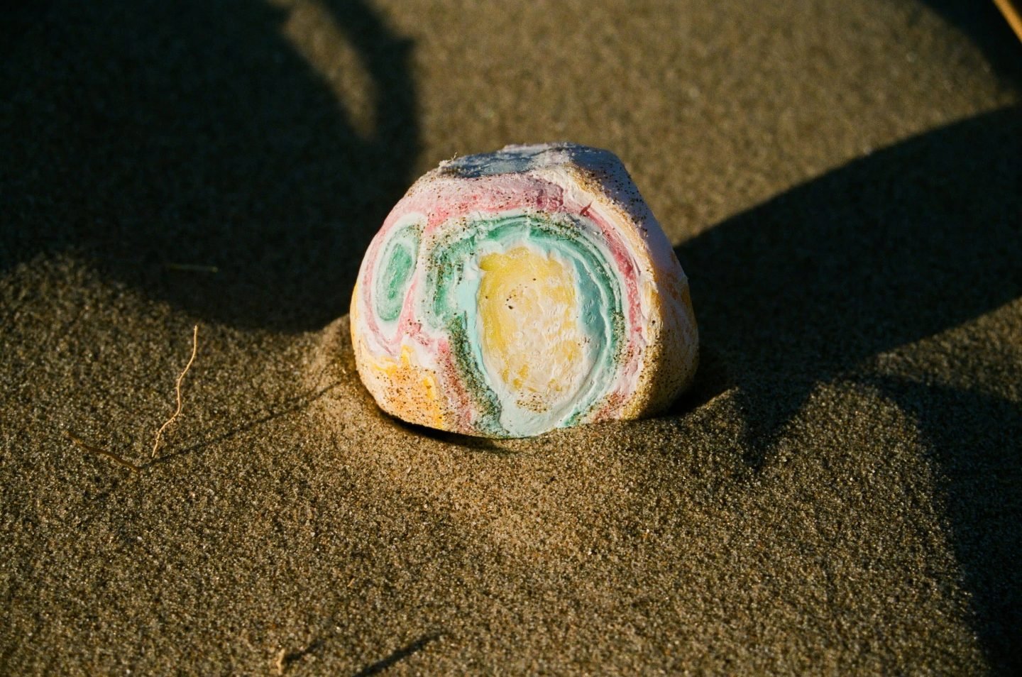 a photo of a colourful stone on the sand from Lina Scheynius photo - essay for Tabayer jewelry